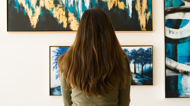 woman watching paintings