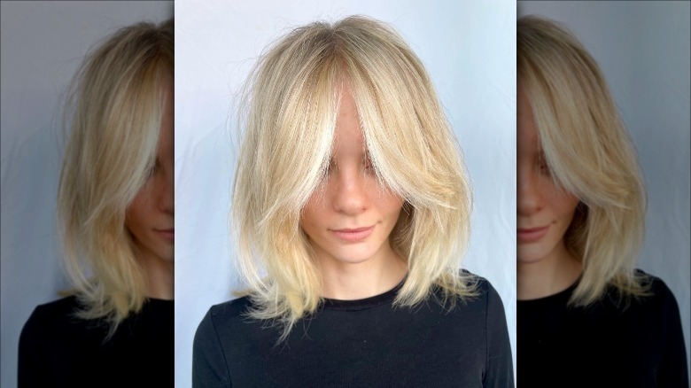 woman with blonde feathered bangs