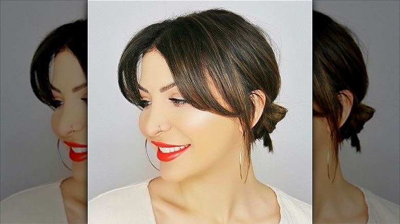 woman with curtain bangs low bun