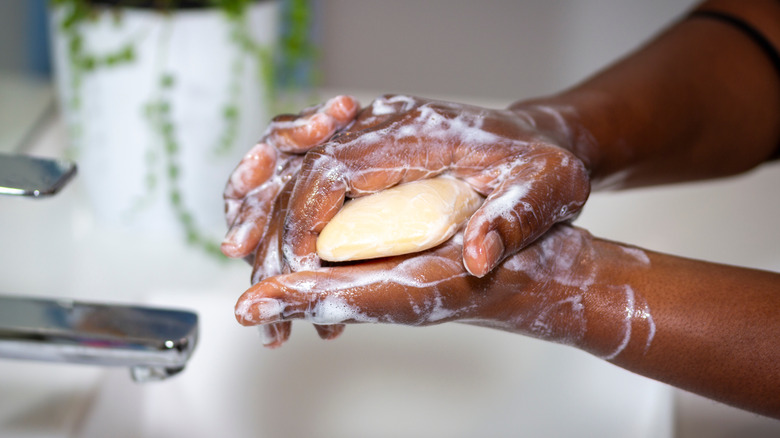 Black woman's hands lathering soap