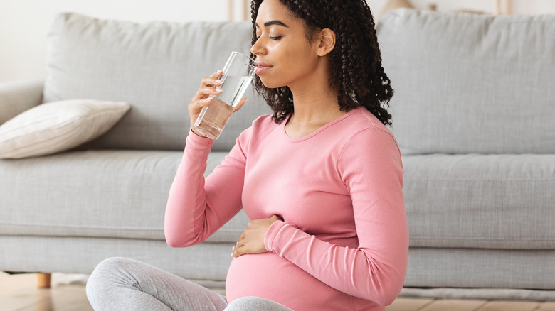 pregnant woman drinks water