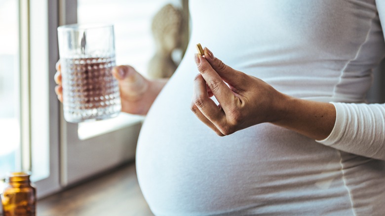 pregnant woman taking medicine