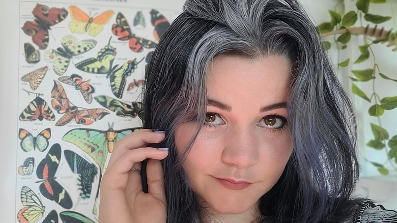 Young woman embracing gray hair