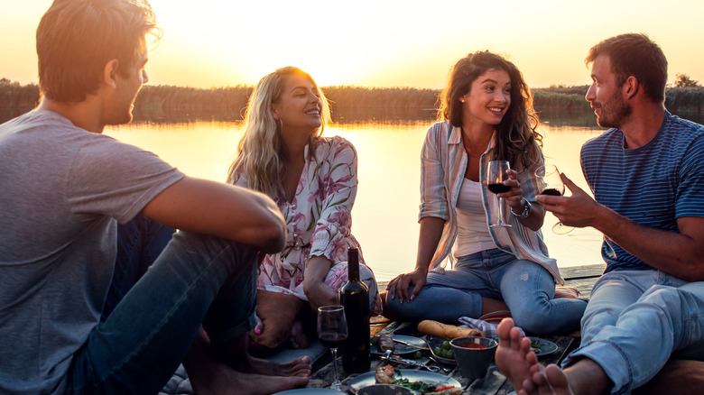 friends hanging out by a lake 