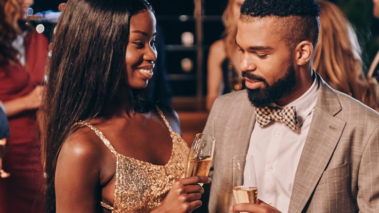 couple holding glasses of wine 