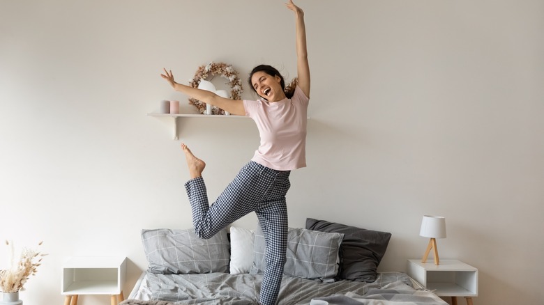 Woman dances on bed