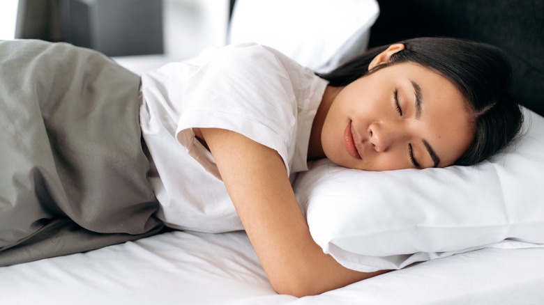 Woman sleeping peacefully in bed 