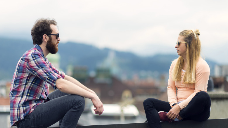 Man and woman talking on bridge