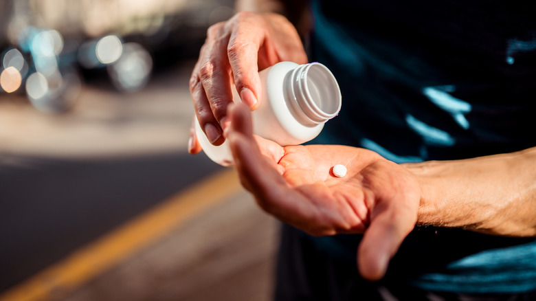 Hands holding painkiller medication