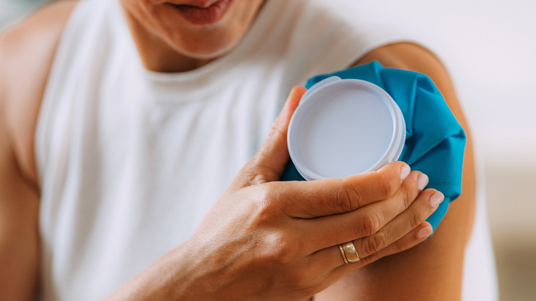 Woman holding ice pack to arm