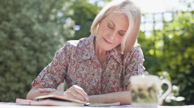 Woman writing in journal