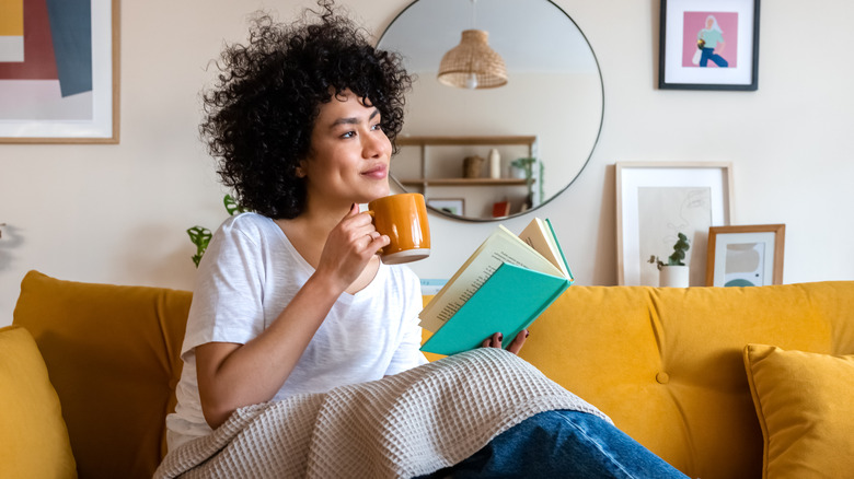 Woman reading a book on the sofa