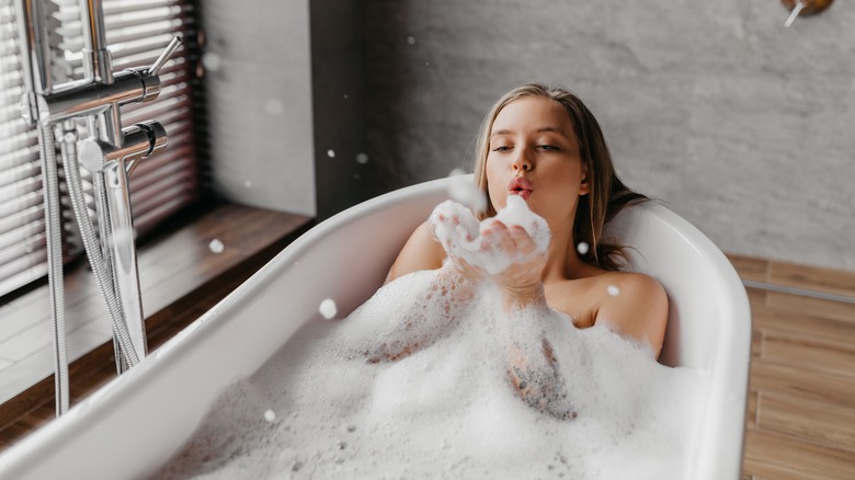 Woman soaks in bubble bath