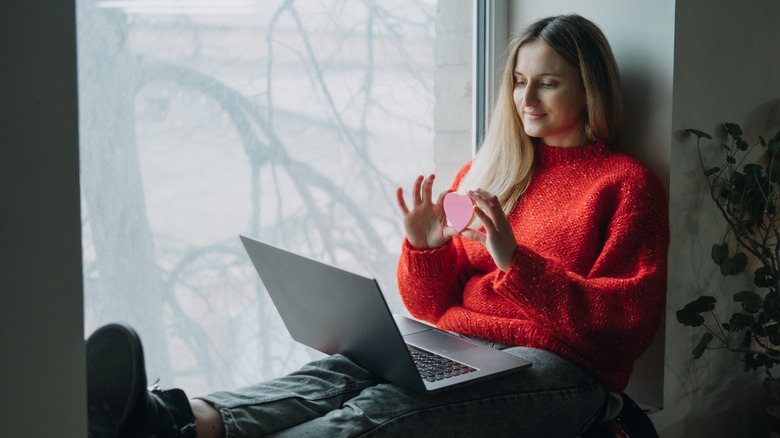 woman holding love heart and laptop