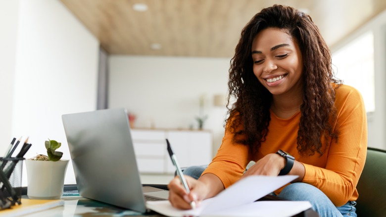 woman writing in notebook