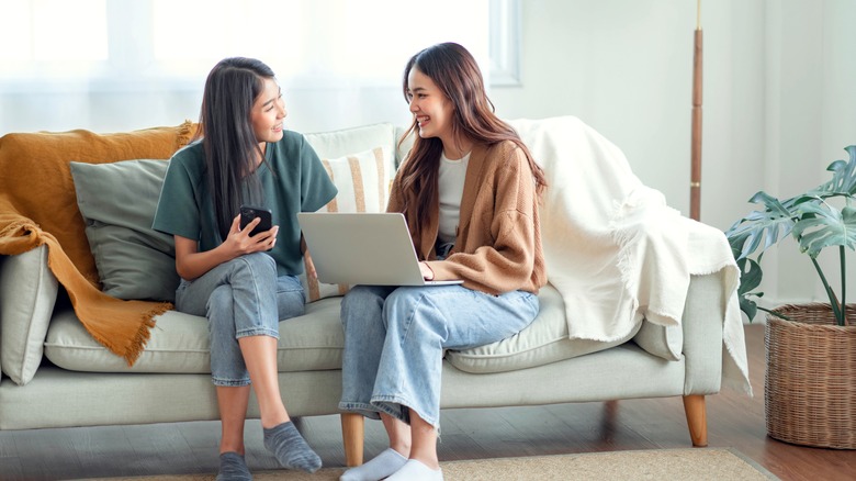 two women talking on couch 