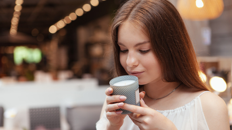 woman smelling scented candle