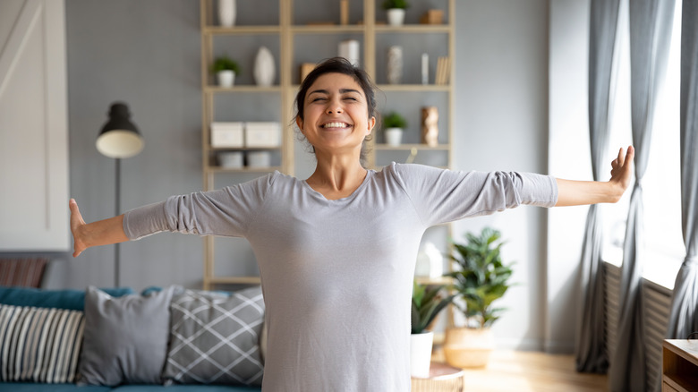 woman smiling while stretching