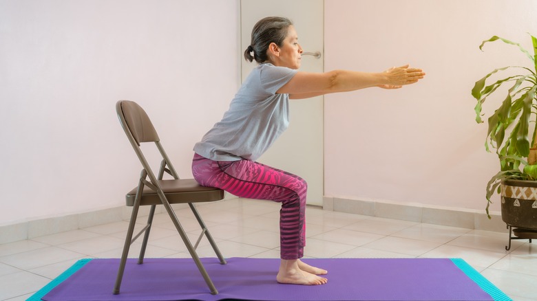 woman practicing chair yoga