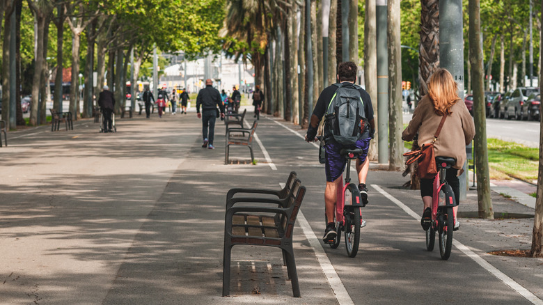 A man and a woman riding bikes