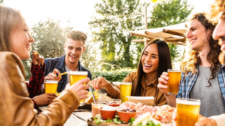 A group of friends having drinks and snacks together