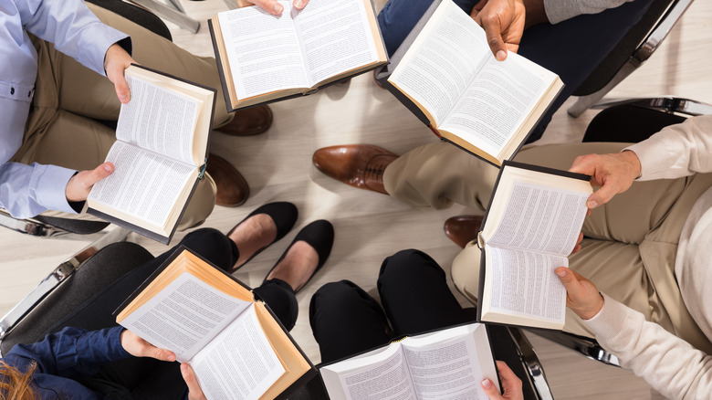 Six people holding books