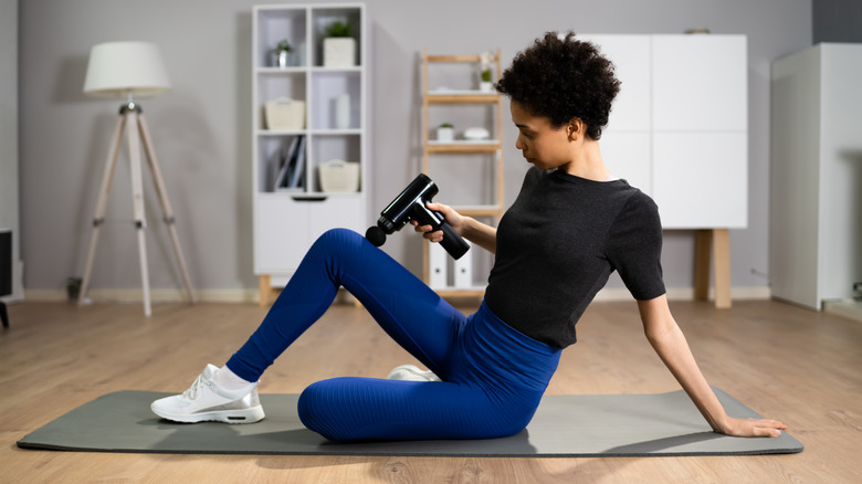 Woman using massage gun