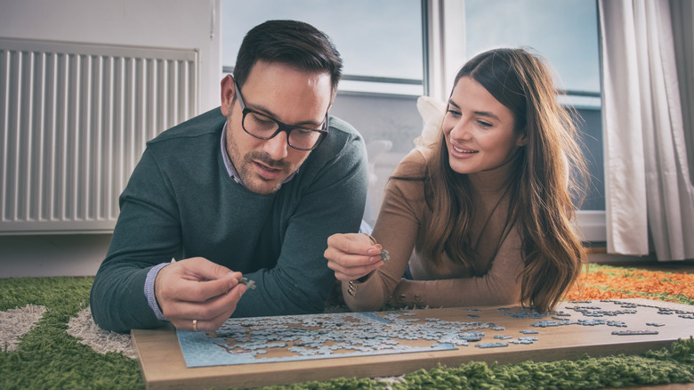 Couple doing puzzle