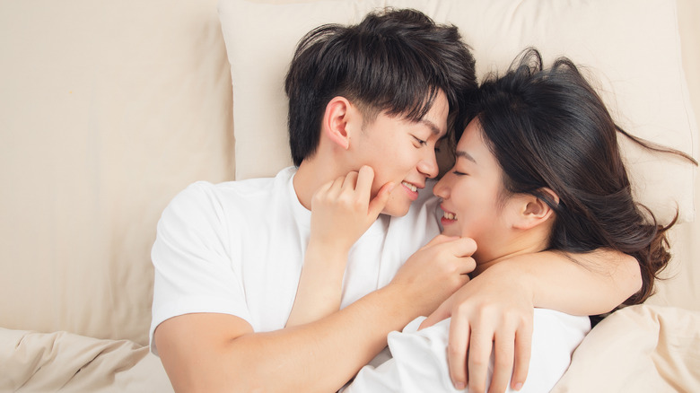 Couple laying in bed