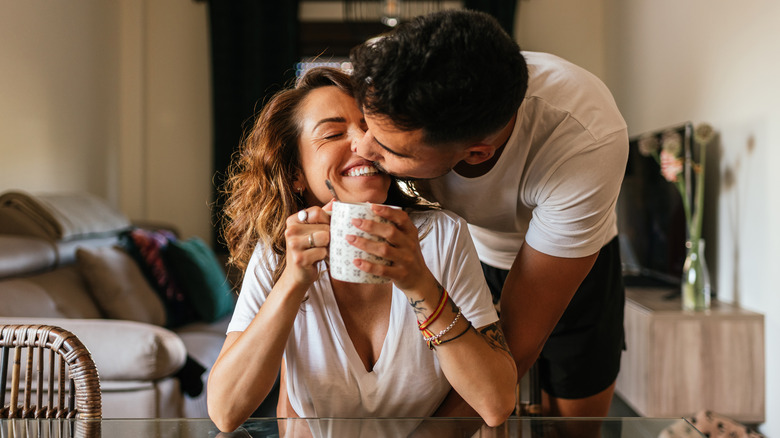 Couple hugging and having coffee