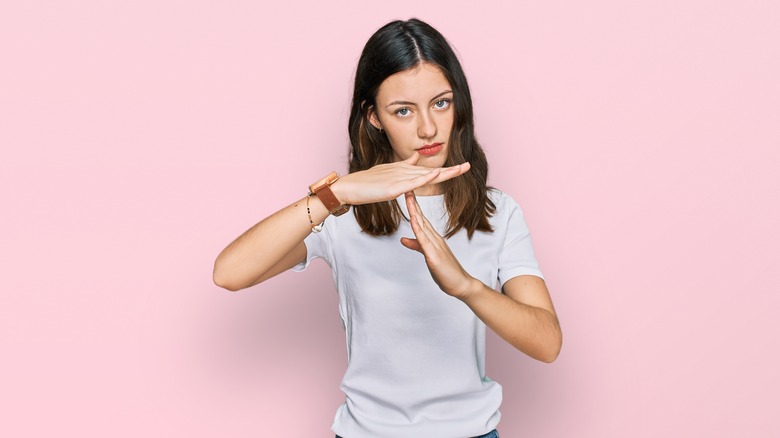 Woman making time out hand symbol