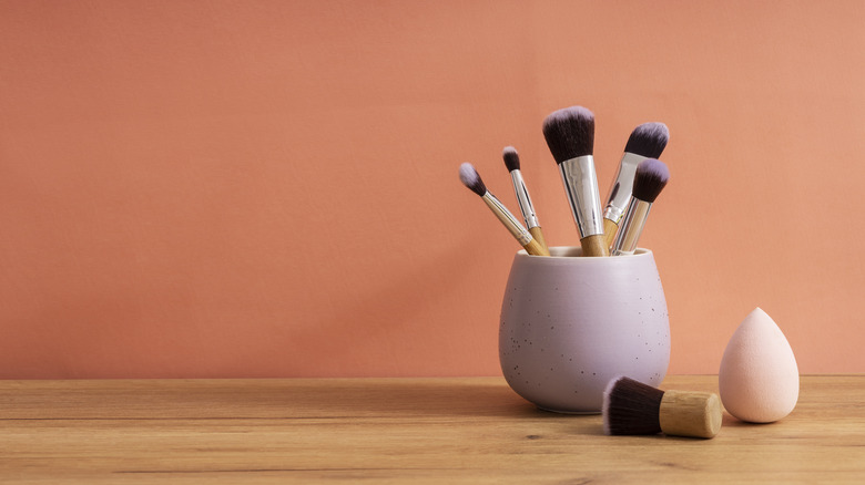 vase holding makeup brushes