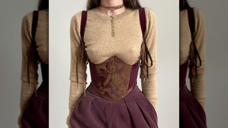 Woman wearing a burgundy corset top