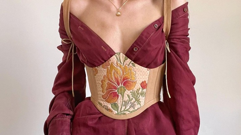 Woman wearing an embroidered corset top