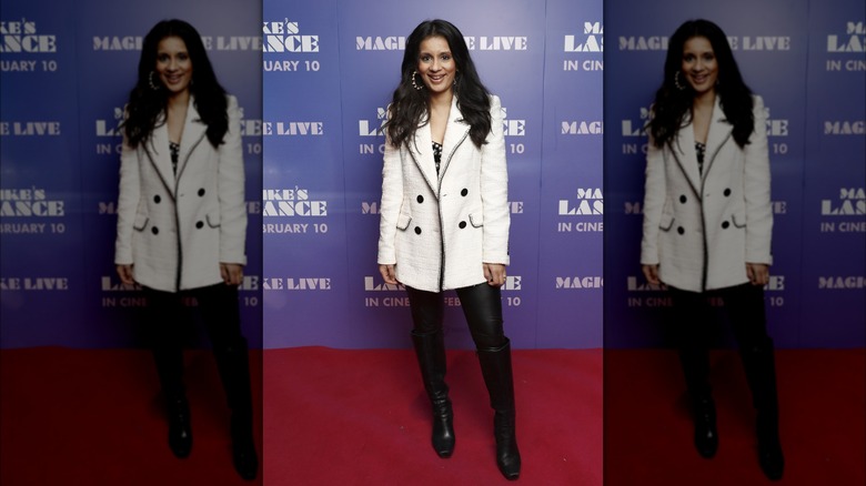 Woman wearing white coat with leggings