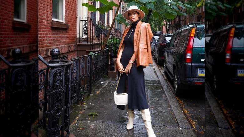 Woman wearing a leather blazer over a knit maxi dress