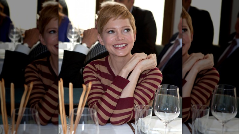 Michelle Williams sitting, smiling