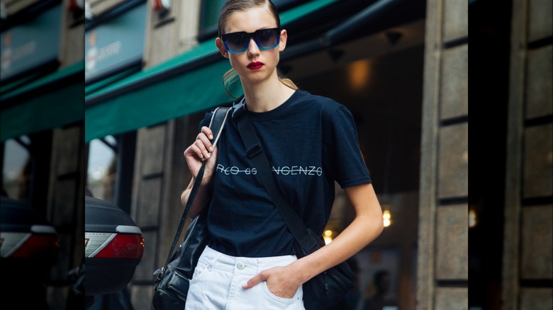 Woman wearing high-waisted bottoms with a t-shirt.