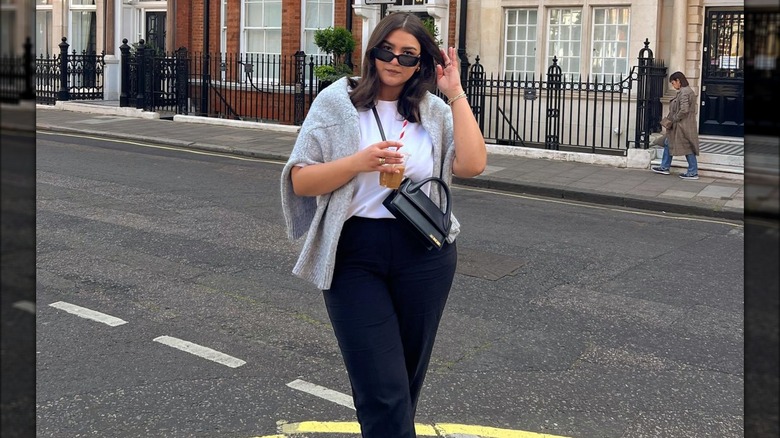 Woman wearing a tucked-in t-shirt.