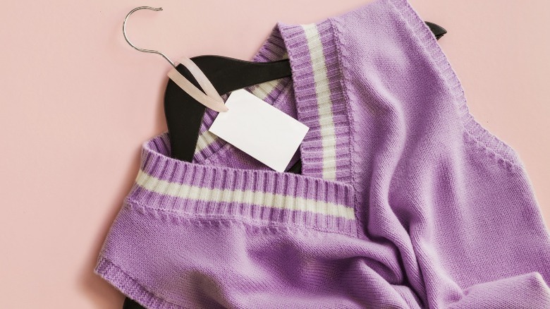 Purple sweater vest on a hanger