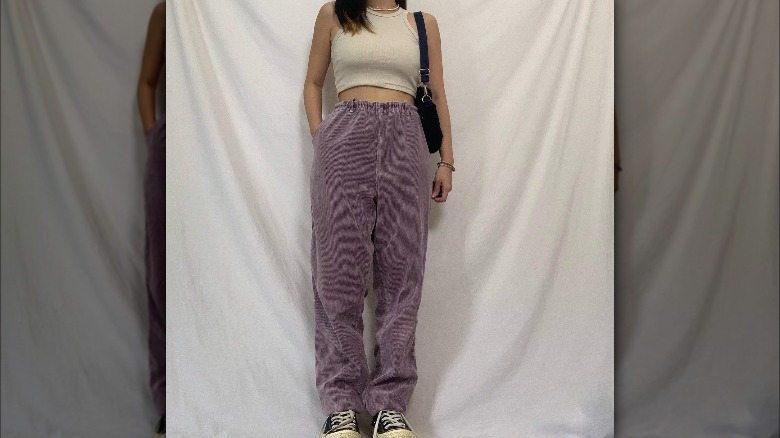 Oversized purple corduroys with a tiny tank top.