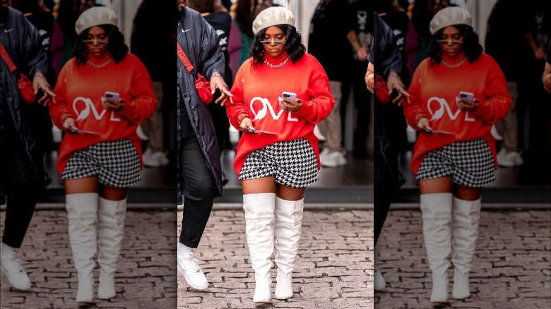 Woman wearing sweater, shorts, and beret