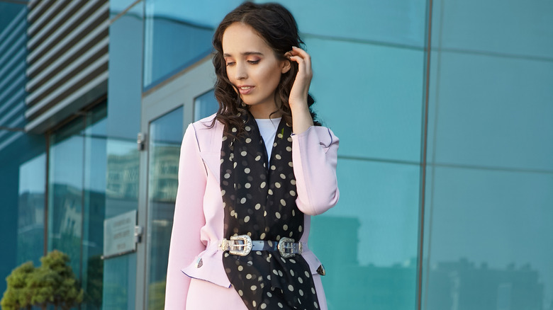 Woman in pink coat with belted scarf