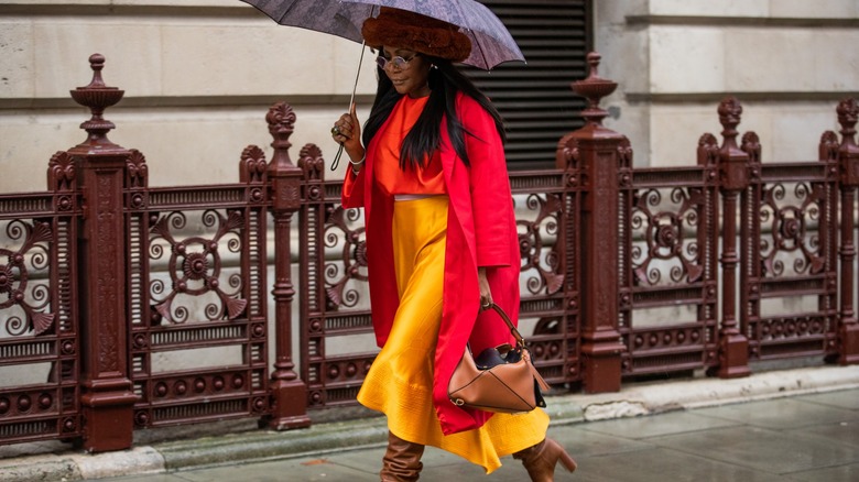 woman wearing slip skirt and coat