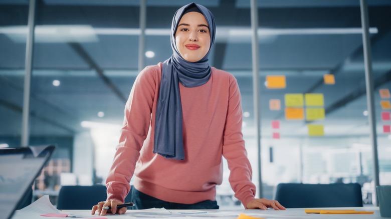 Muslim woman smiling in office