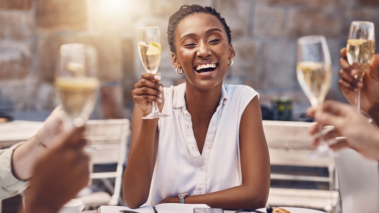 woman holding champagne at restaurant