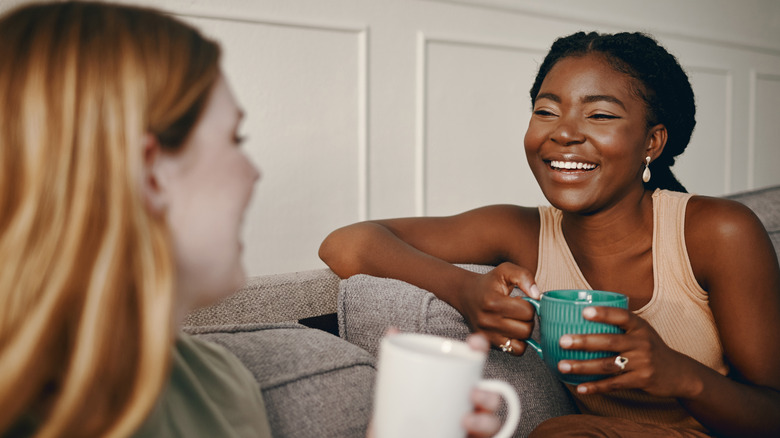 two friends talking on couch