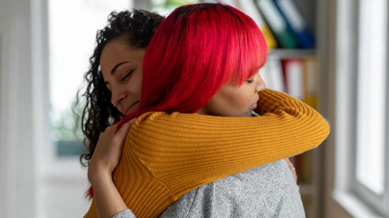 two female friends hugging