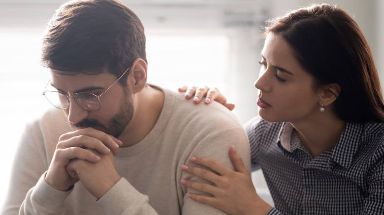 woman consoling man