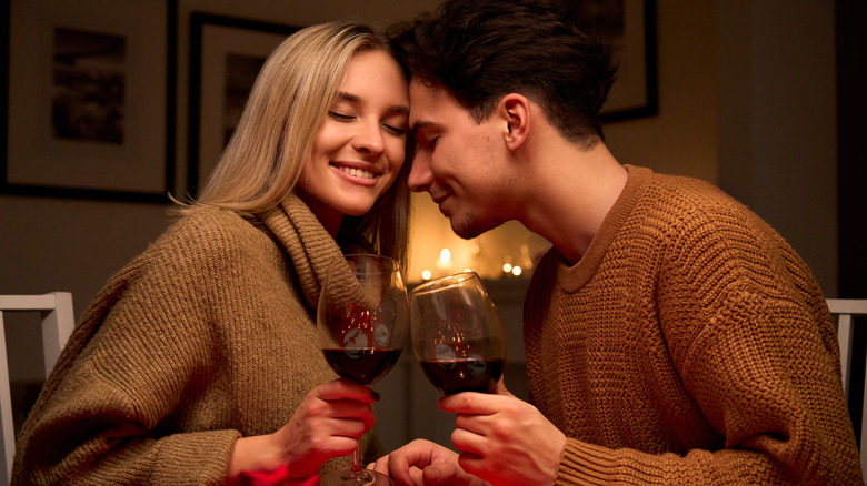 Couple toasts wine glasses